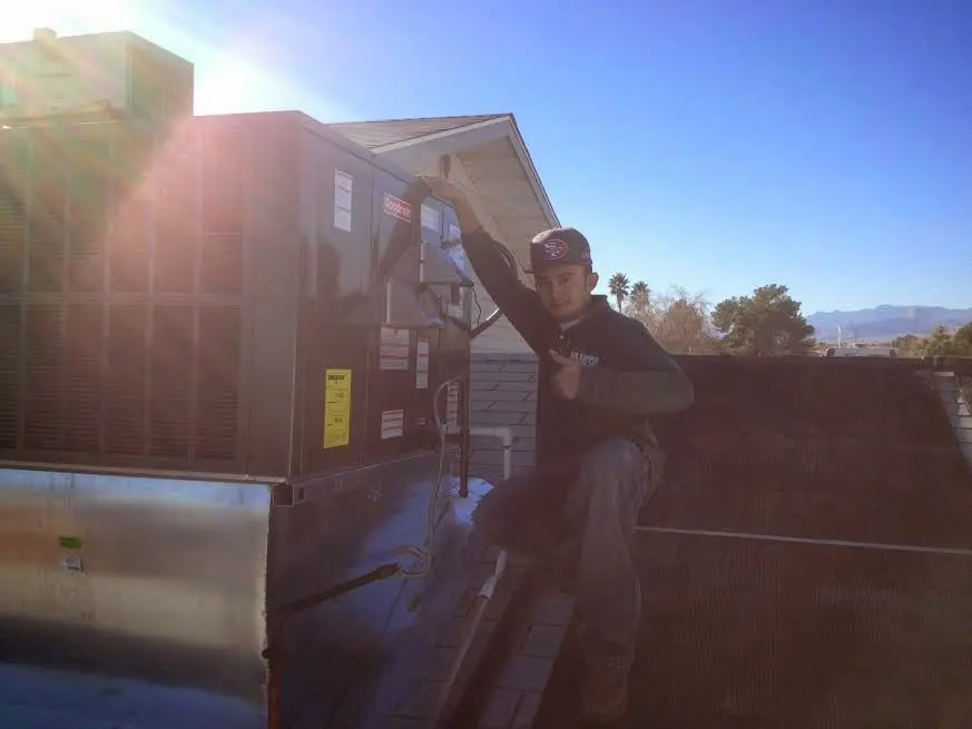 HVAC technician performing HVAC Inspection on a rooftop unit in South Run